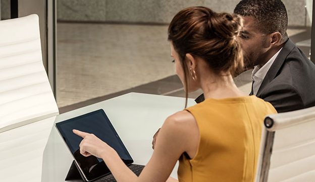 Man and woman behind laptop