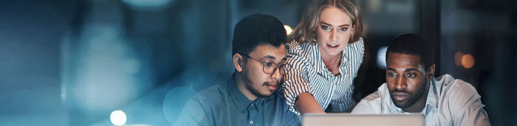 two man and a woman looking at laptop screen
